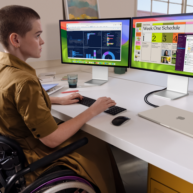 Person working at two external display screens that are connected to a closed 15-inch MacBook Air in Starlight finish