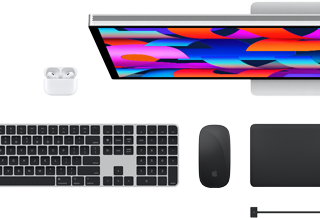 Top view of Mac accessories: Studio Display, AirPods, Magic Keyboard, Magic Mouse and Magic Trackpad